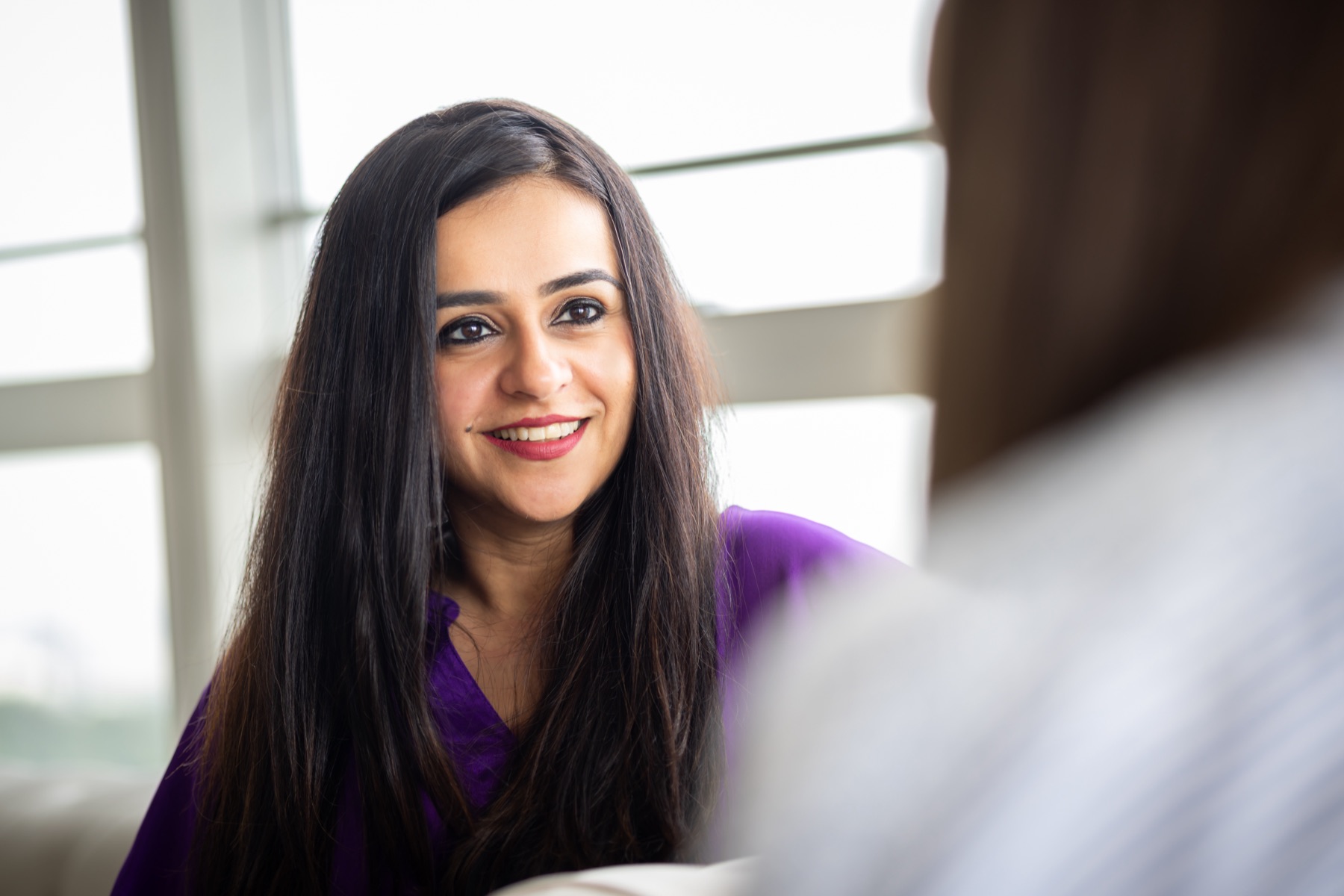 Ritika listening during a coaching session