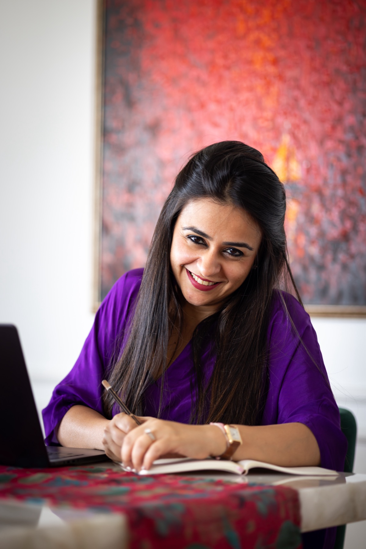 Ritika writing at a table