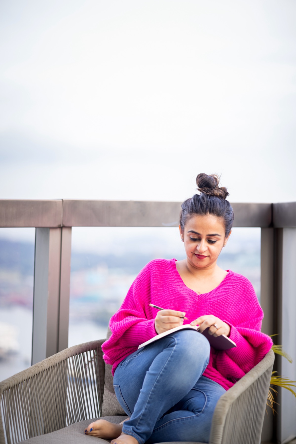 Ritika journaling on a balcony