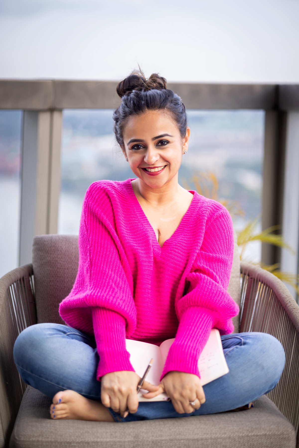 Ritika smiling with a notebook
